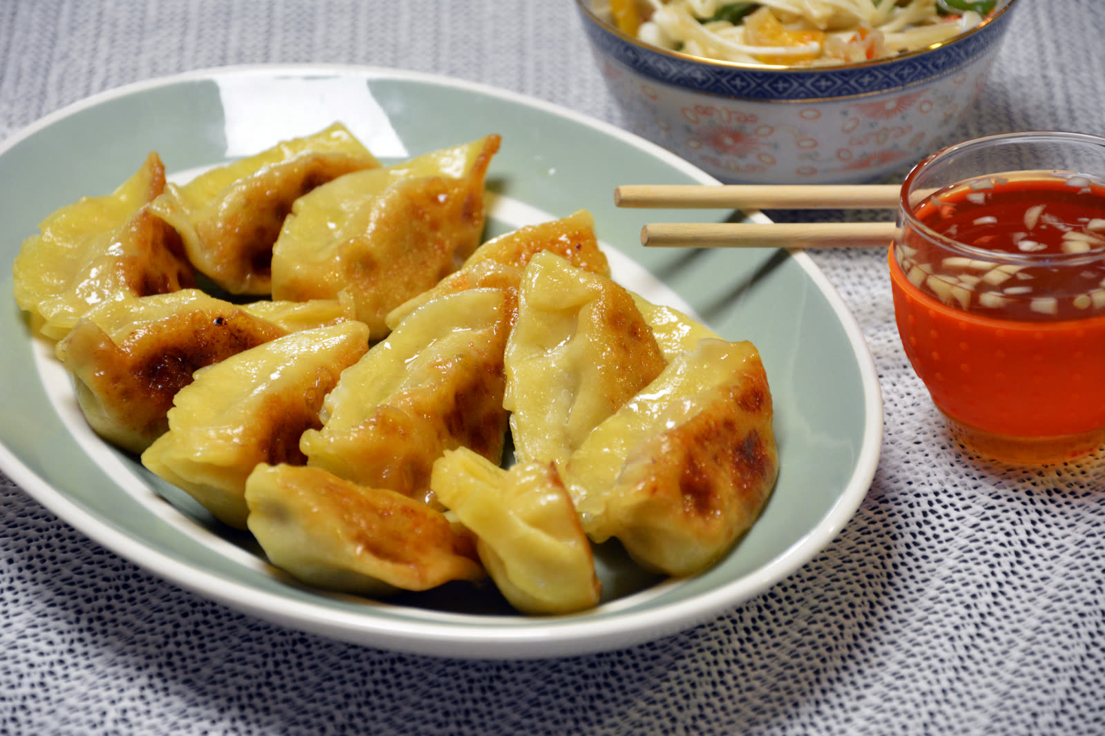 Selbst gemachte Dumplings mit knuspriger Unterseite aus der Pfanne, serviert mit Dip